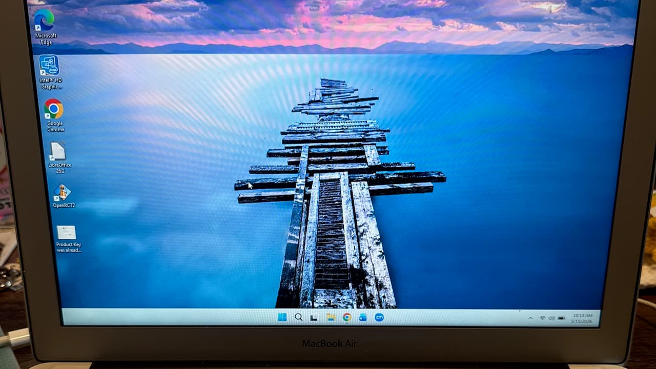 A screenshot of a 2013 MacBook Air, running Windows 11 with a light color scheme and a boat dock background.